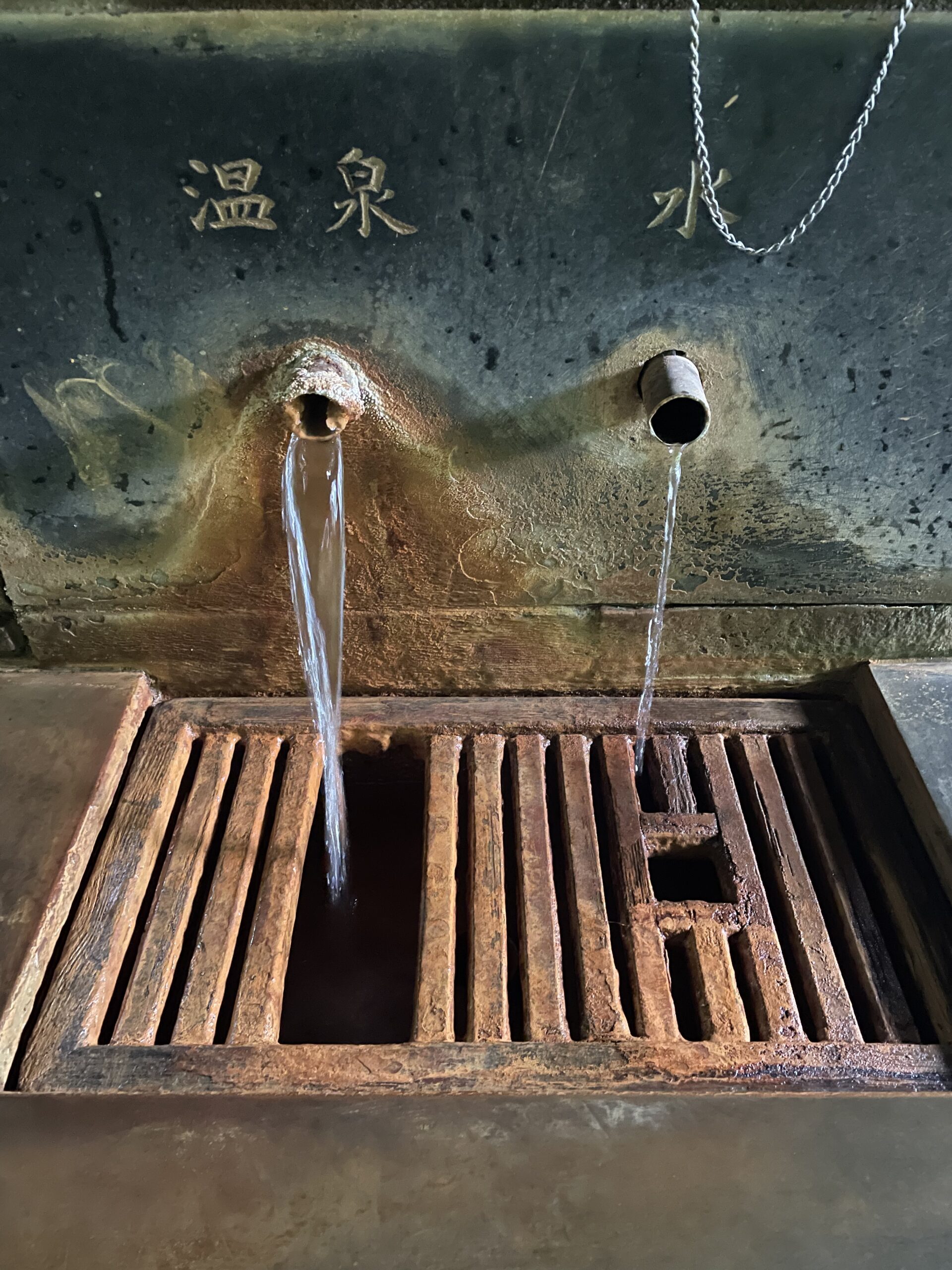 Rust-brown faucets with hot spring drinkable water